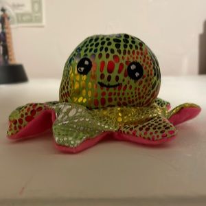 A goffa brand plush with rainbow spots and a pink bottom.